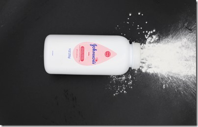 Pasadena,MD/USA-Jul 05,2020: White bottle of Johnson's baby powder isolated on black background. Focus on text Johnson's at center of bottle; other in blur.